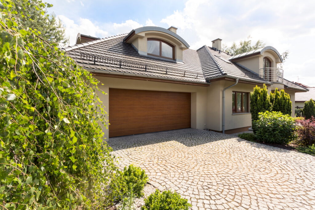 Detached house exterior with cobblestone driveway